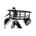 A headlight mounted to a front basket on the front of a grey Ebike