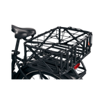 Detail view of the Cargo Net strapped over a basket installed on an ebike